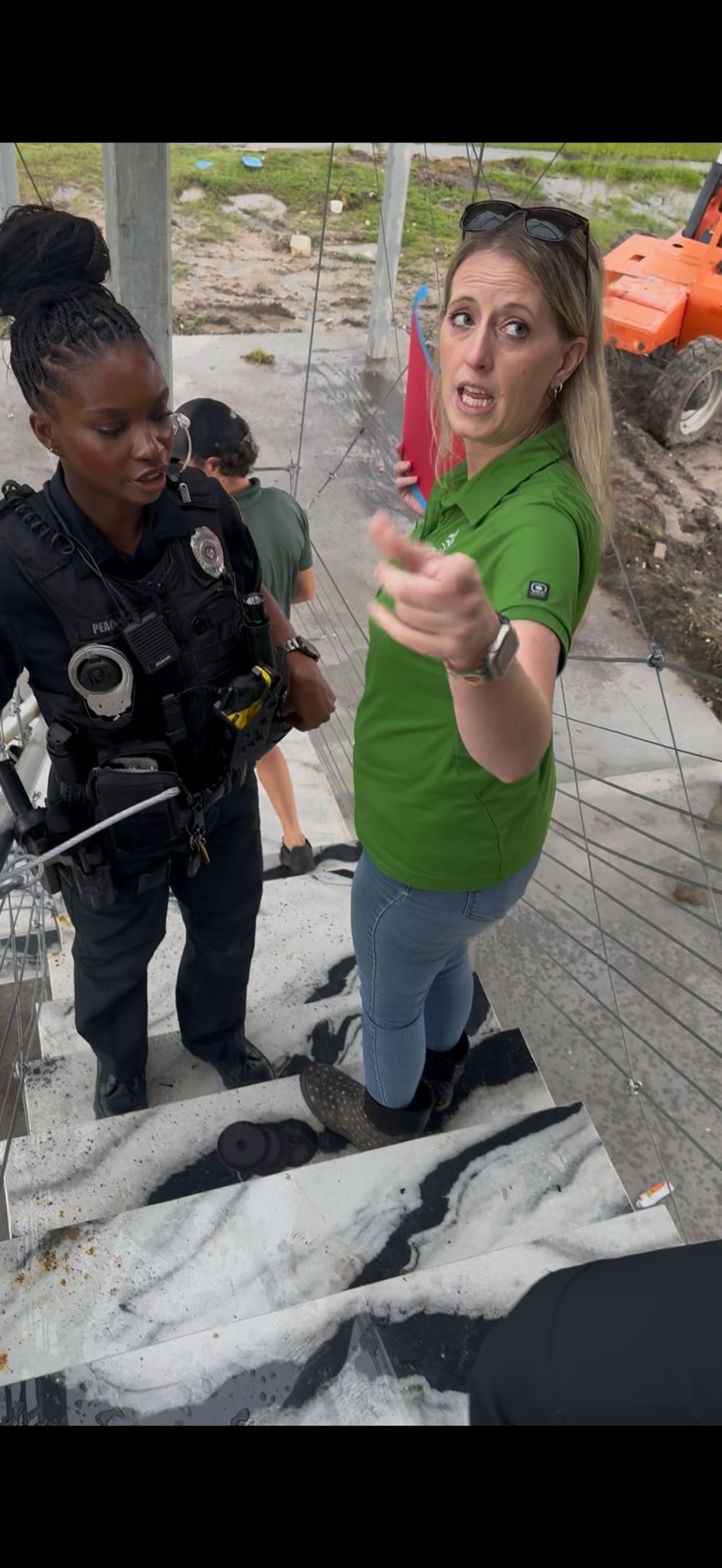 Tara Busby with armed Biloxi police officer and Kyle Illing at 1606 Beach Boulevard, June 30, 2025