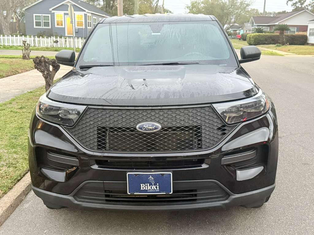 Front view of black Ford Explorer with small decorative Biloxi established 1699 plate. No 3-inch markings visible.