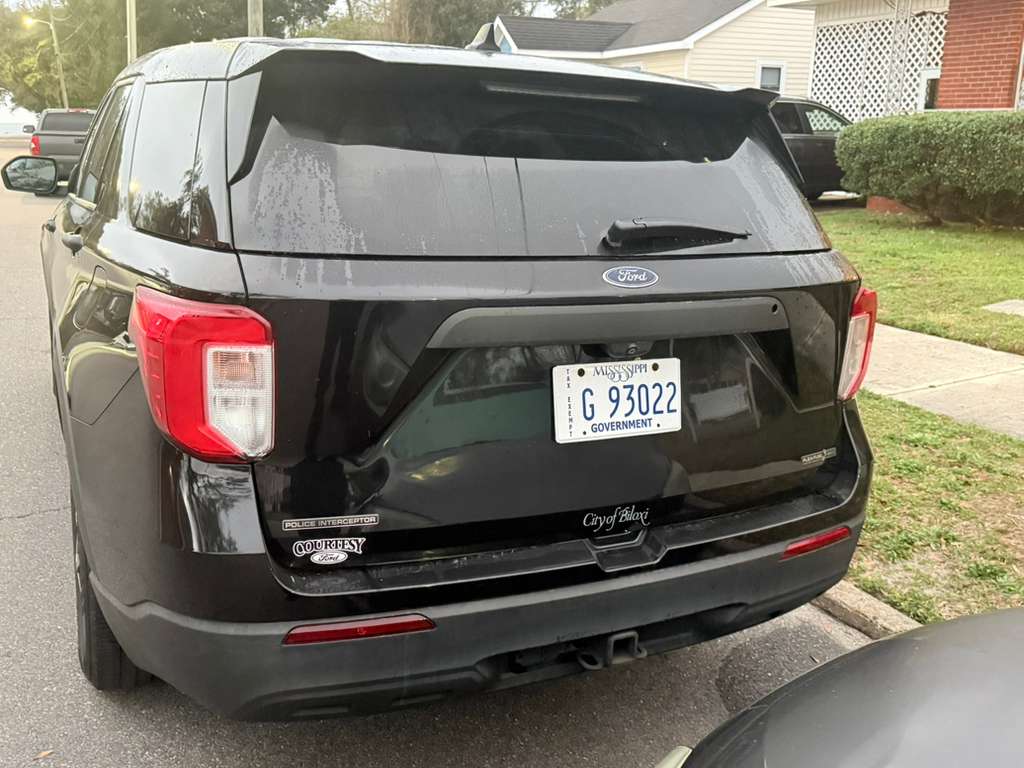 Rear view showing Mississippi GOVERNMENT plate G 93022, Police Interceptor badge, and tiny City of Biloxi script in black on black.